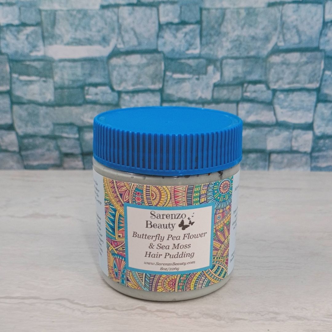 Jar of Sarenzo Beauty Butterfly Pea Flower & Sea Moss Hair Pudding with a blue lid on a textured surface.